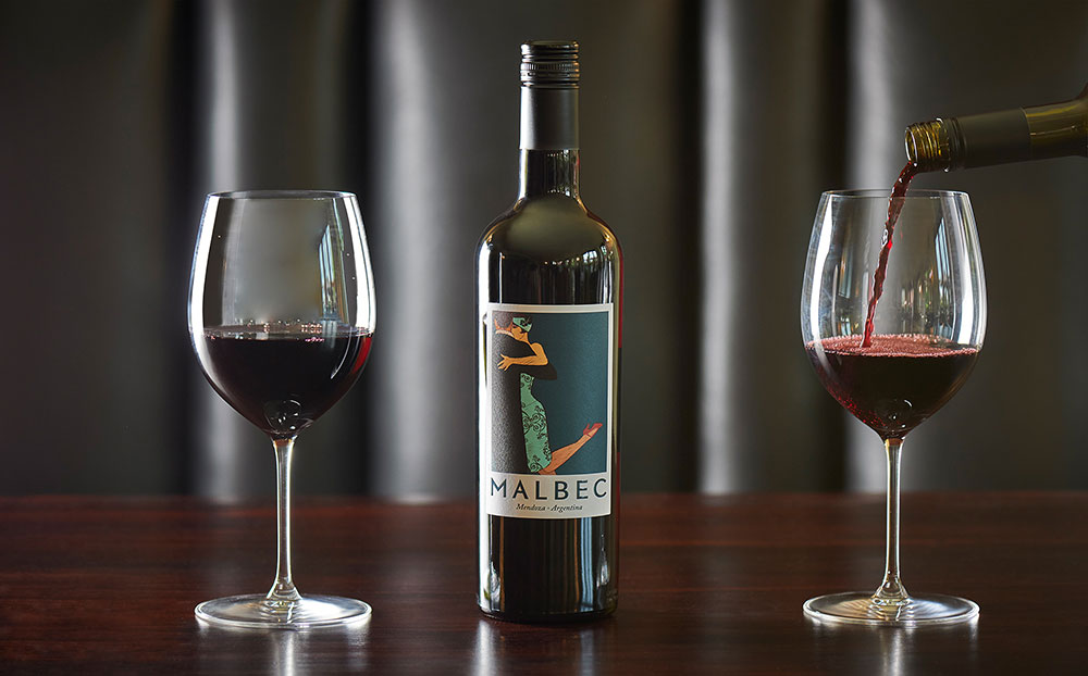 wine glasses with red wine and bottle of wine